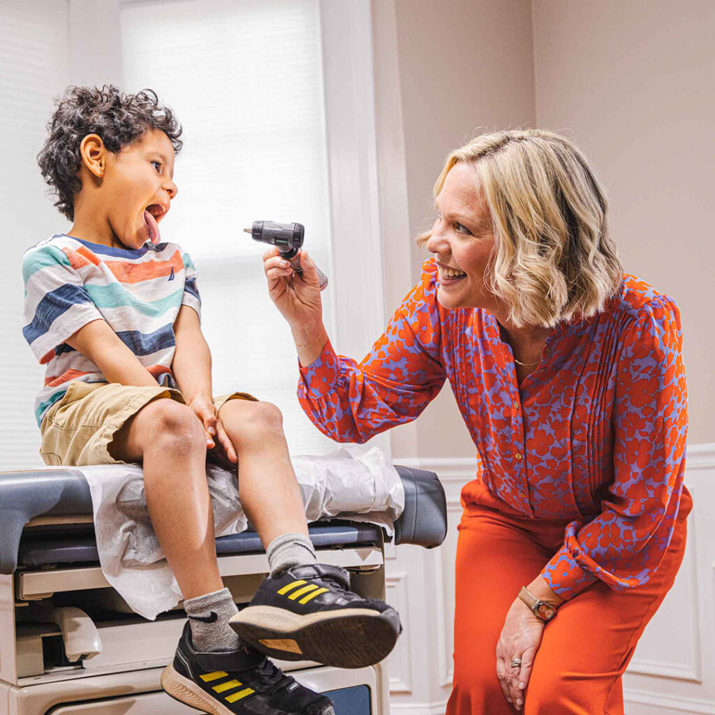 Doctor measures the temperature of a child